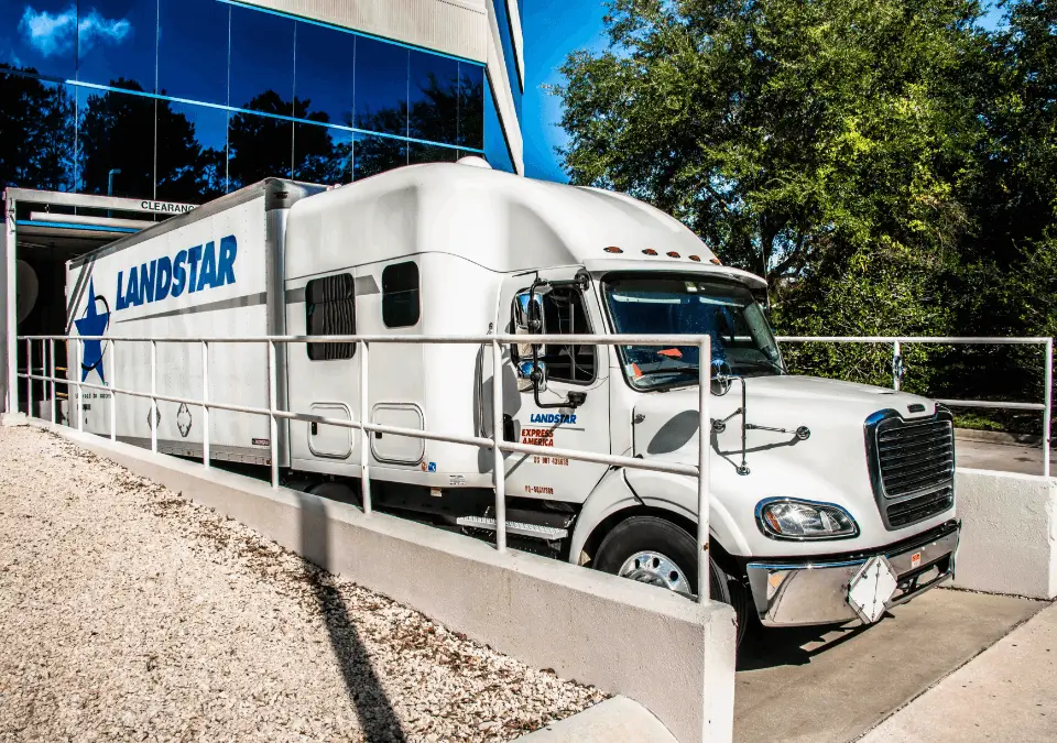 A large semi truck waiting at a loading dock.